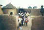 Bawku, Ghana, 1993. Typical style of housing in the North of Ghana. The children in the picture are members of the Kussie tribe. Photo by Wayne Breslyn.